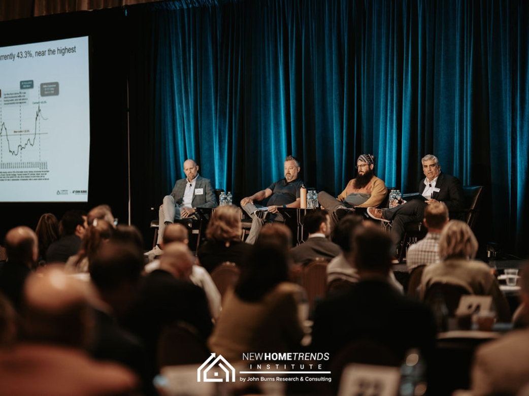 Panel of speakers on stage 