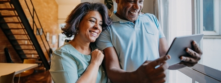 mature couple looking at ipad